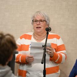 Sharon Butler speaks into a microphone.