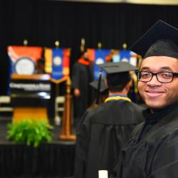 ChattState Graduate Turns and Smiles While Walking to Stage