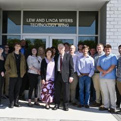 Lew and Linda Myers surrounded by students at the opening of the Myers Technology Wing