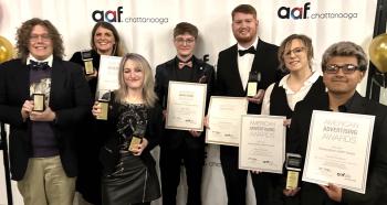 Seven ADDY Award winners in formal attire stand side-by-side holding their awards. Left to right: Sam Hammond, Tess Little, Kaitlyn Whalen, Jaden Bane, Christopher Phillips, Allison Ferguson, and Freddy Pantaleon