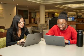 Two students look at their computers in ChattState's library. Two students look at their computers in ChattState's library.