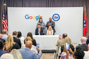 Rob Magliaro and Flora Tidings sit in front of a Google and TBR sign while onlookers cheer. Rob Magliaro and Flora Tidings sit in front of a Google and TBR sign while onlookers cheer.