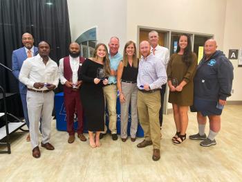 Hall of Fame inductees stand side-by-side holding plaques. Hall of Fame inductees stand side-by-side holding plaques.
