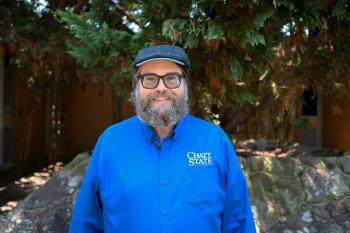 James McCoy A bearded man in a wool hat smiles.