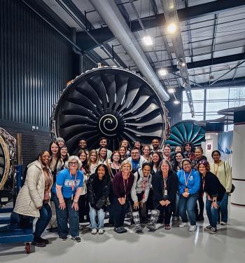Rolls-Royce ChattState students and instructors stand before a jet engine while visiting the Rolls-Royce facility in England.