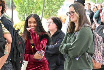 Dean's List 2025 Three younger women stand in line as one smiles toward the camera.