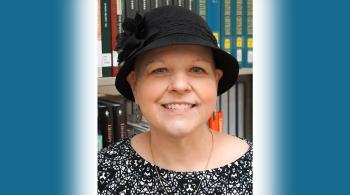 headshot of woman wearing a hat
