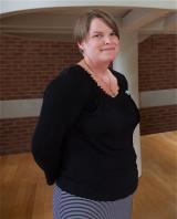 Amanda Bennett poses in front of stairwell of the CBIH building.