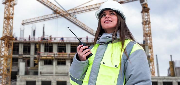 Woman communicates on a construction site