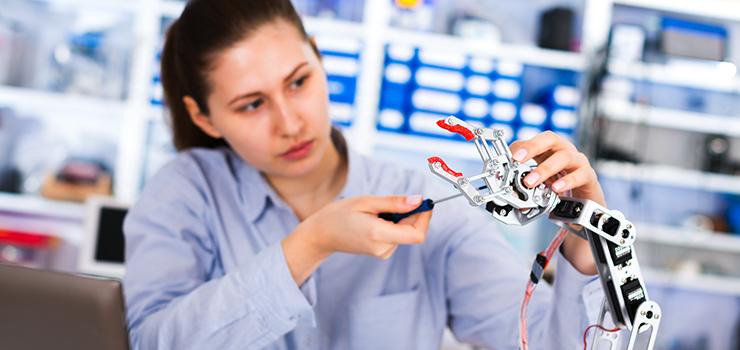 woman assembles a robotic part